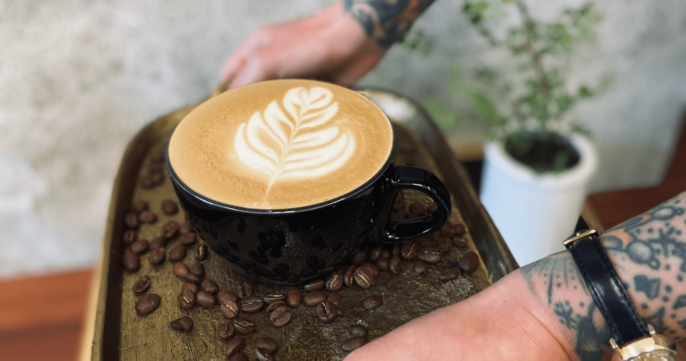 A Vanilla Latte on a gold tray