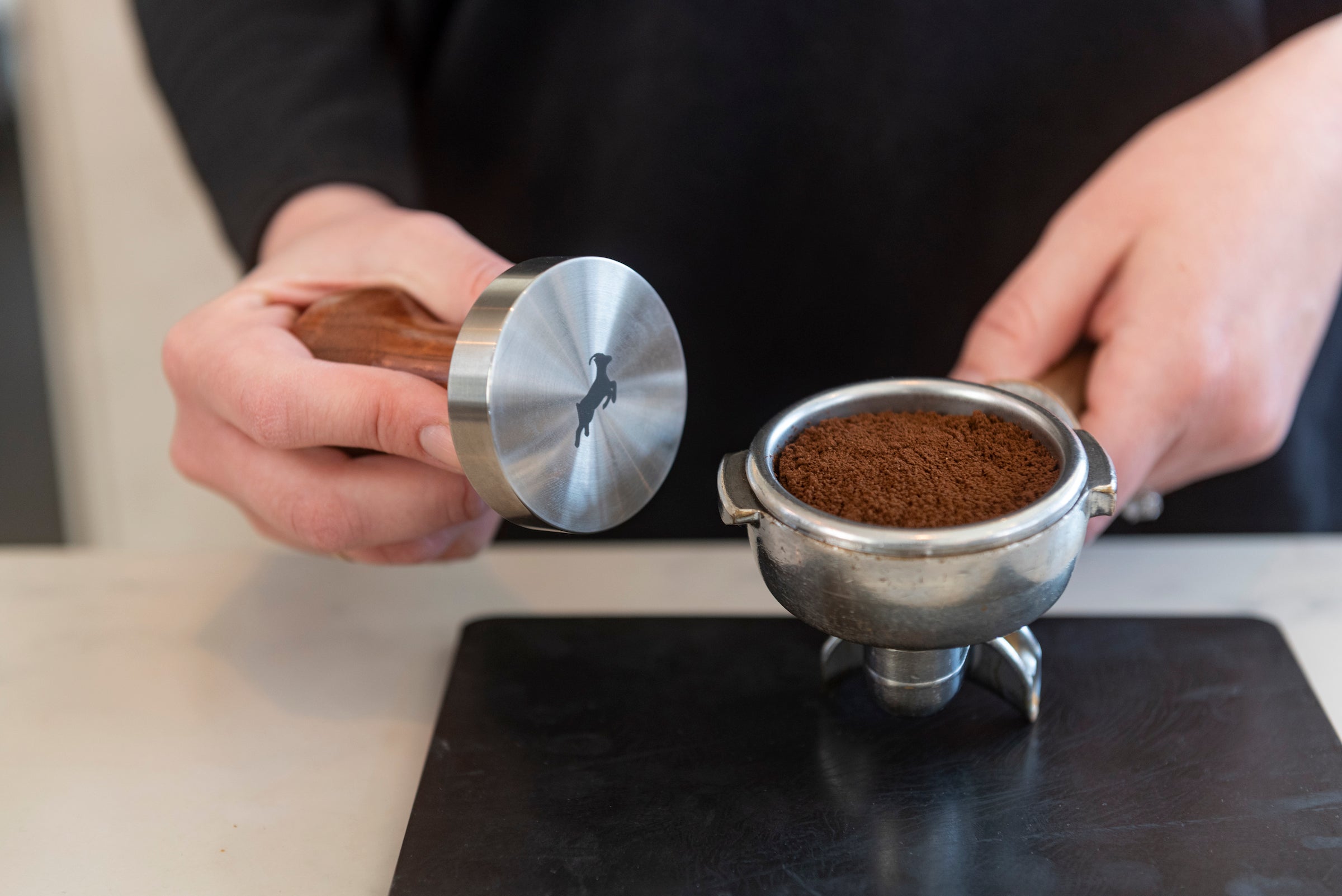 Tamping a shot of espresso coffee with a Kaldi's Coffee tamper