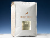 A 5lb bag of 700 sits on marble countertop in front of an uplit blue wall