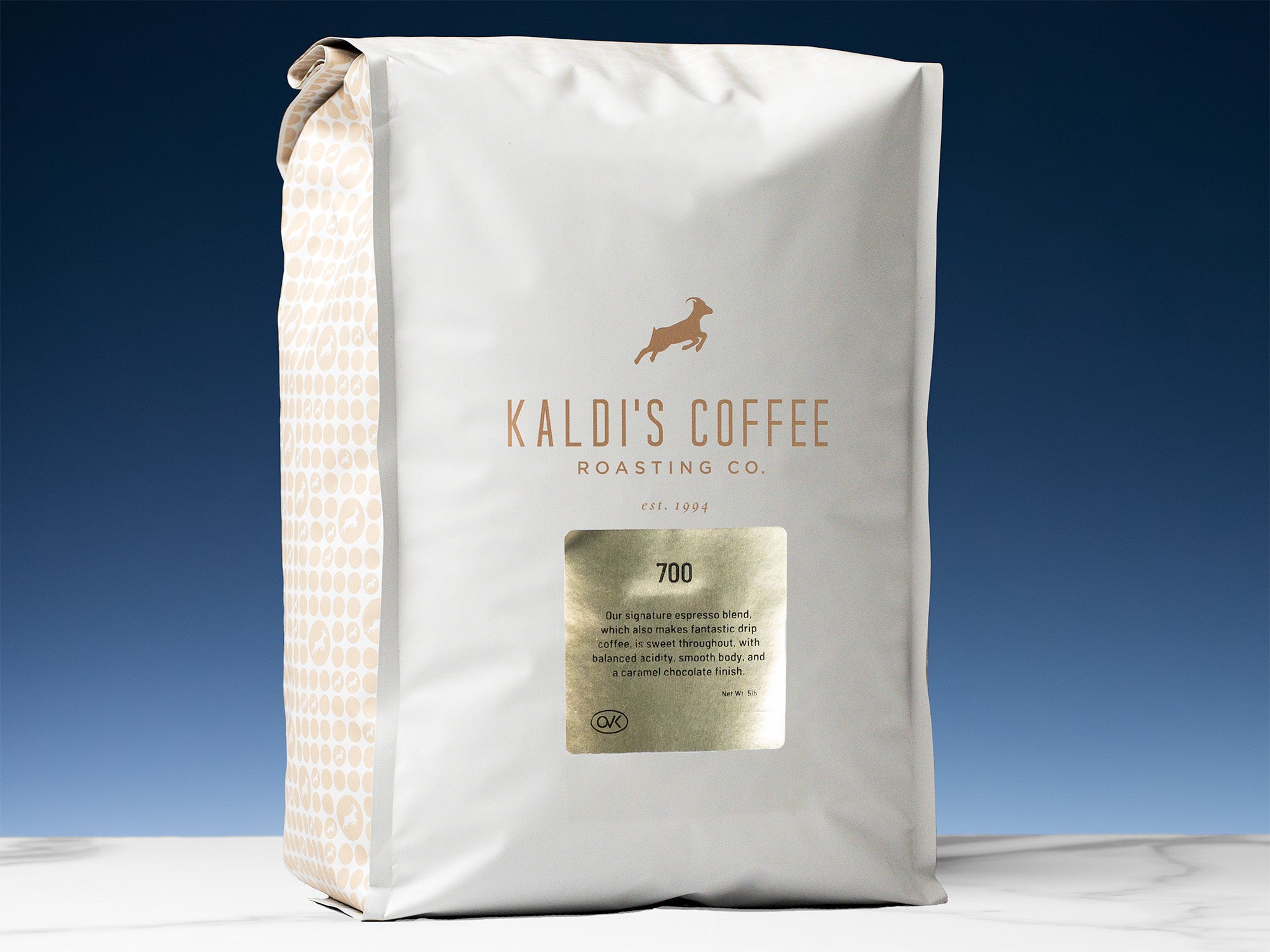 A 5lb bag of 700 sits on marble countertop in front of an uplit blue wall