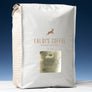 A 5lb bag of 700 sits on marble countertop in front of an uplit blue wall