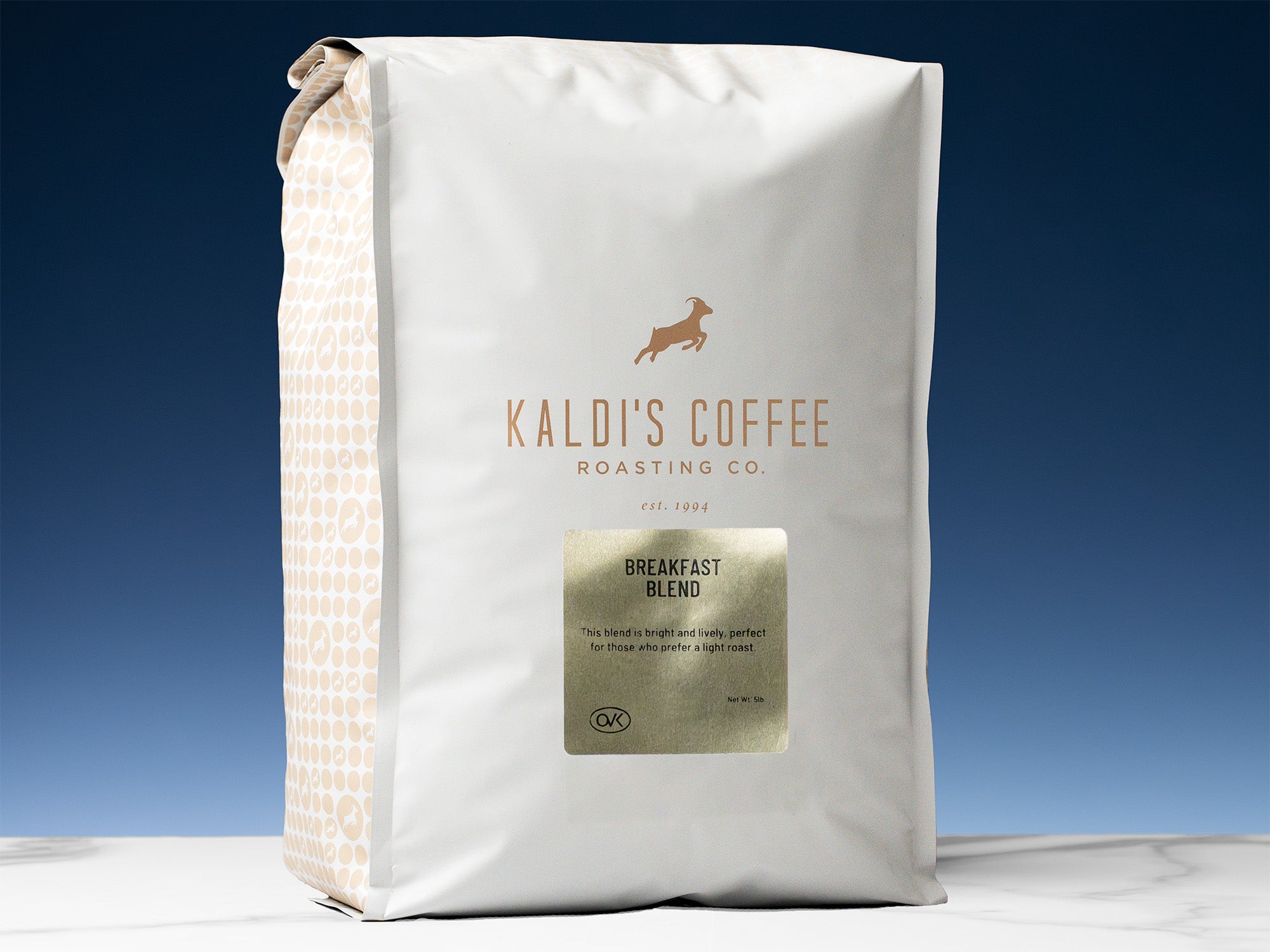 A 5lb bag of Brekfast Blend sits on marble countertop in front of an uplit blue wall
