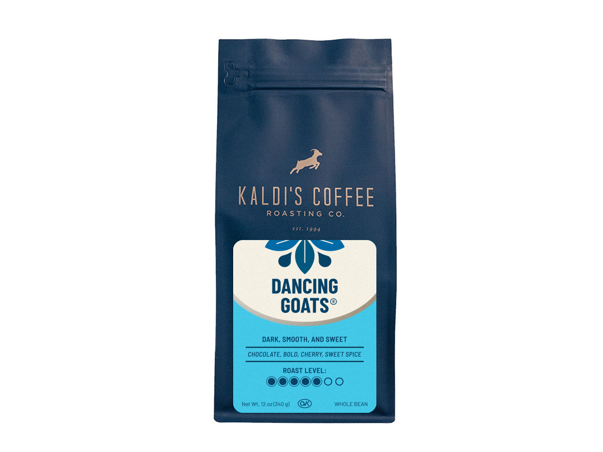 A product photo of a dark blue bag of coffee. The bag is rectangular with a resealable top. In the center is a white label with a drawing of a goat jumping over the words "Kaldi's Coffee Roasting Co."  Below that, the words "Dancing Goats" are in a unique font.  The label also lists tasting notes and a roast level indicator. The bag says "Whole Bean" at the bottom.