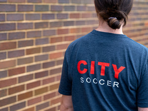 Back of the Versin 2 Game Day Tumbler shirt that reads "CITY SOCCER"