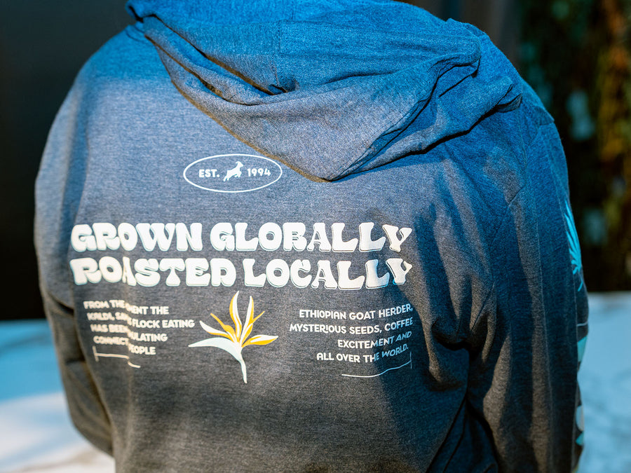 Back of the hoodie that states "Grown Globally, Roasted Locally"