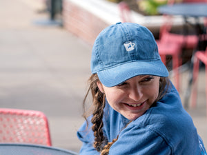 Wearing the logo diner mug hat on a patio