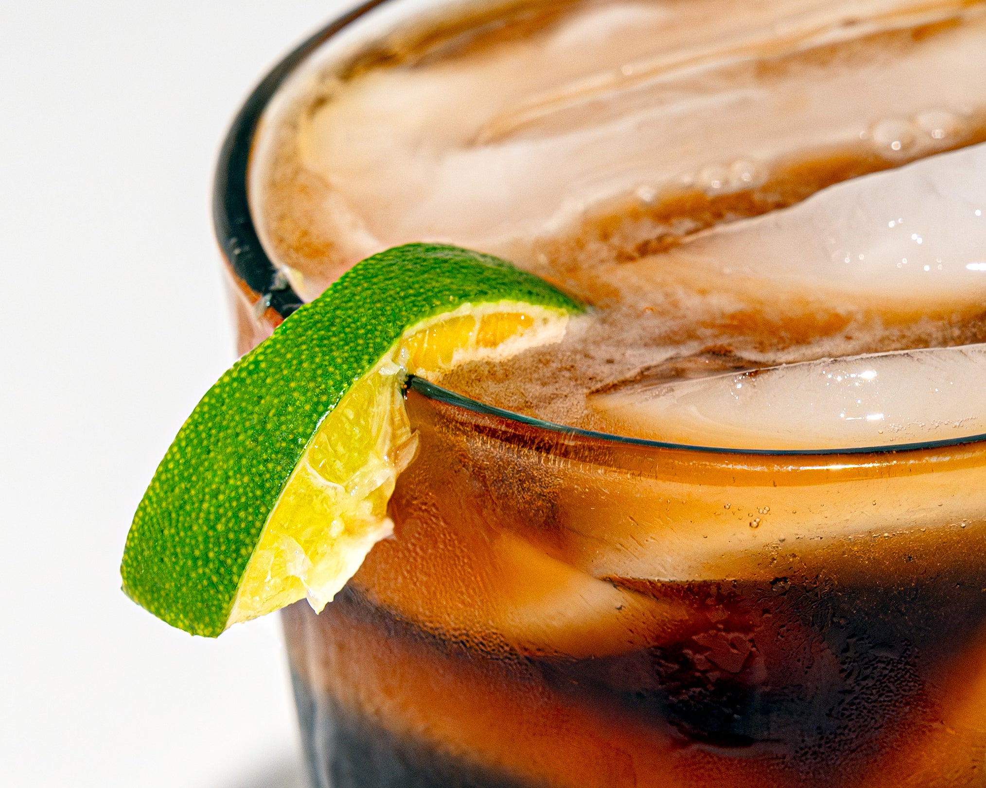 A wedge of lime sits on the rim of a Key Lime Cold Brew Seltzer