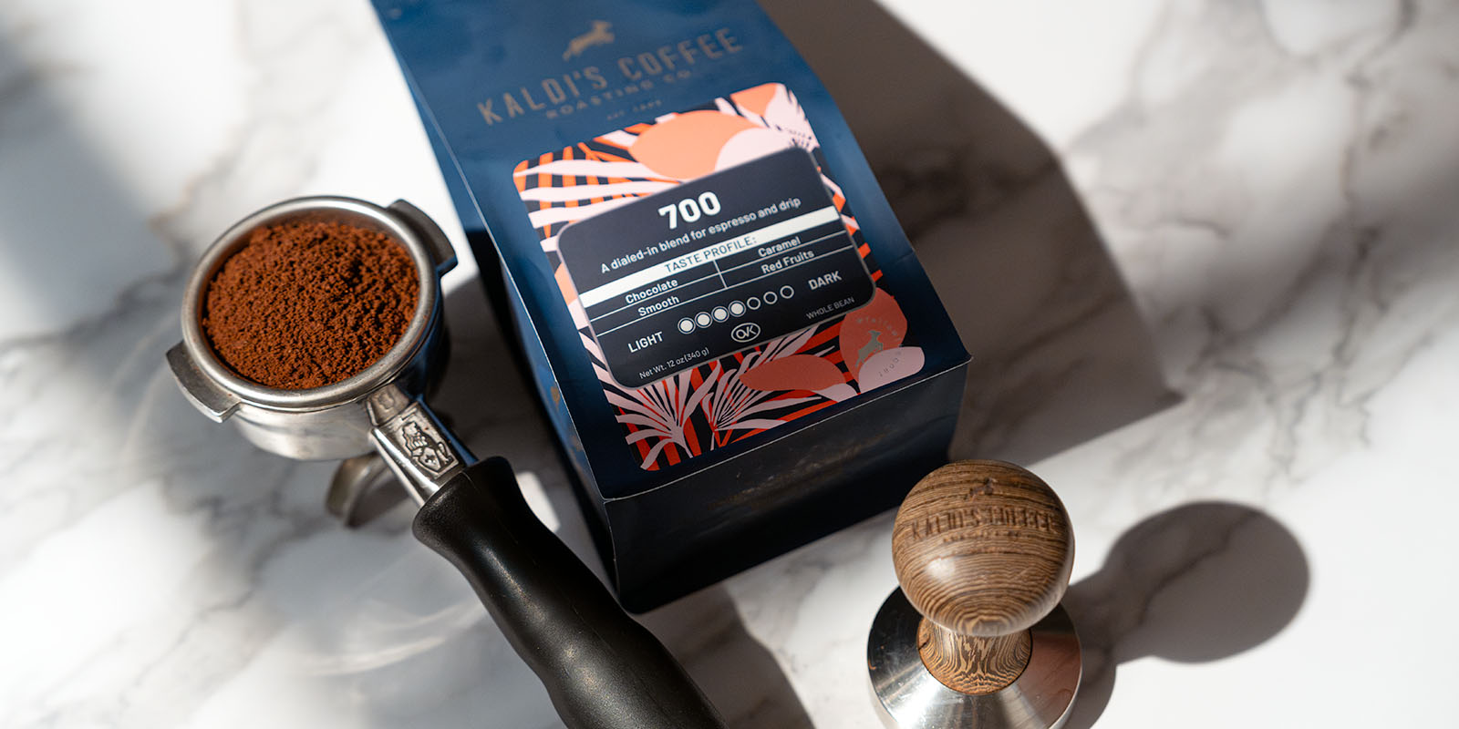 A 12oz bag of 700 with portafilter and tamper