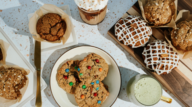 pastries on plates and drinks on speckled counter