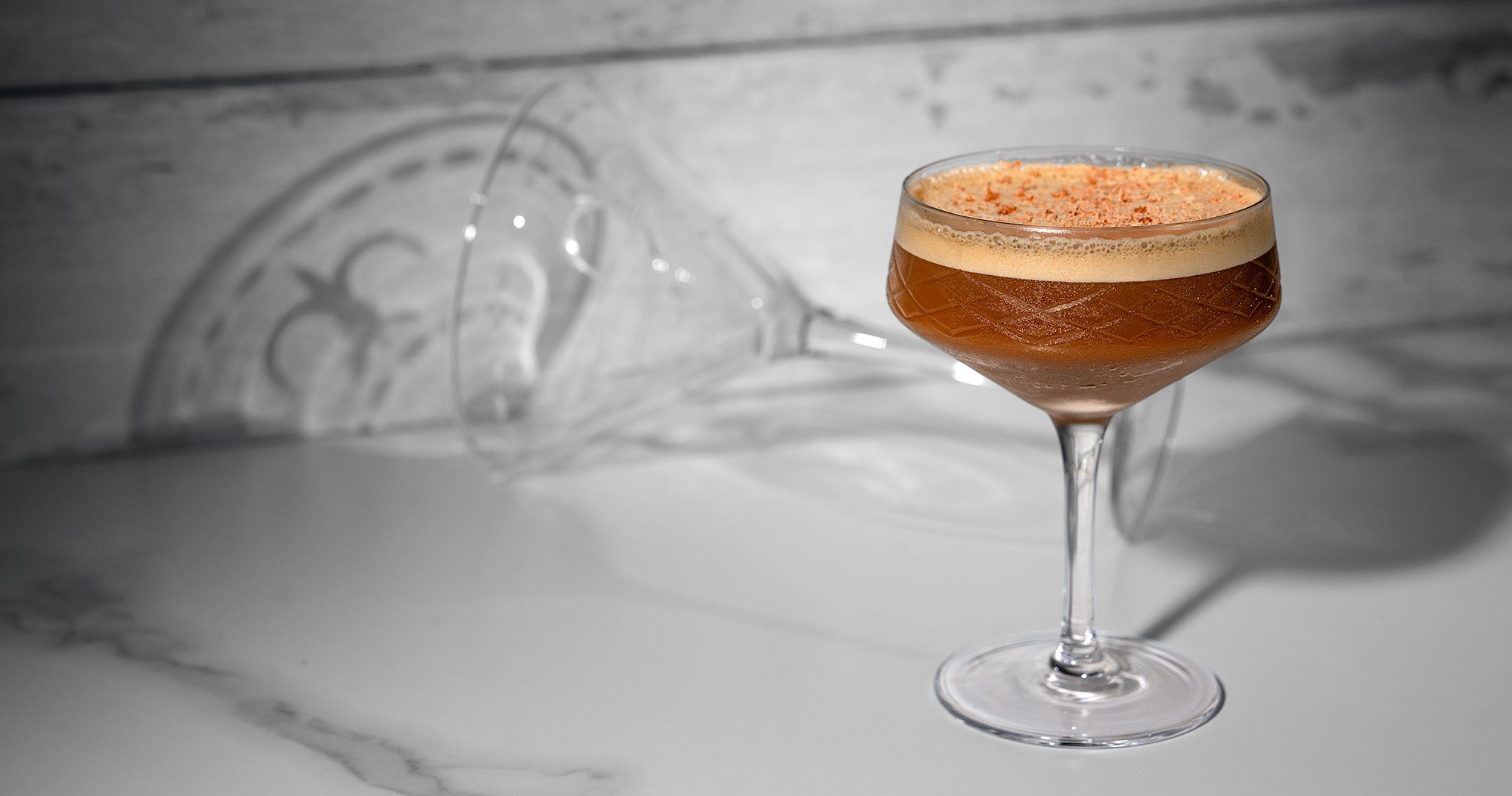 pouring an espresso martini into a martini glass