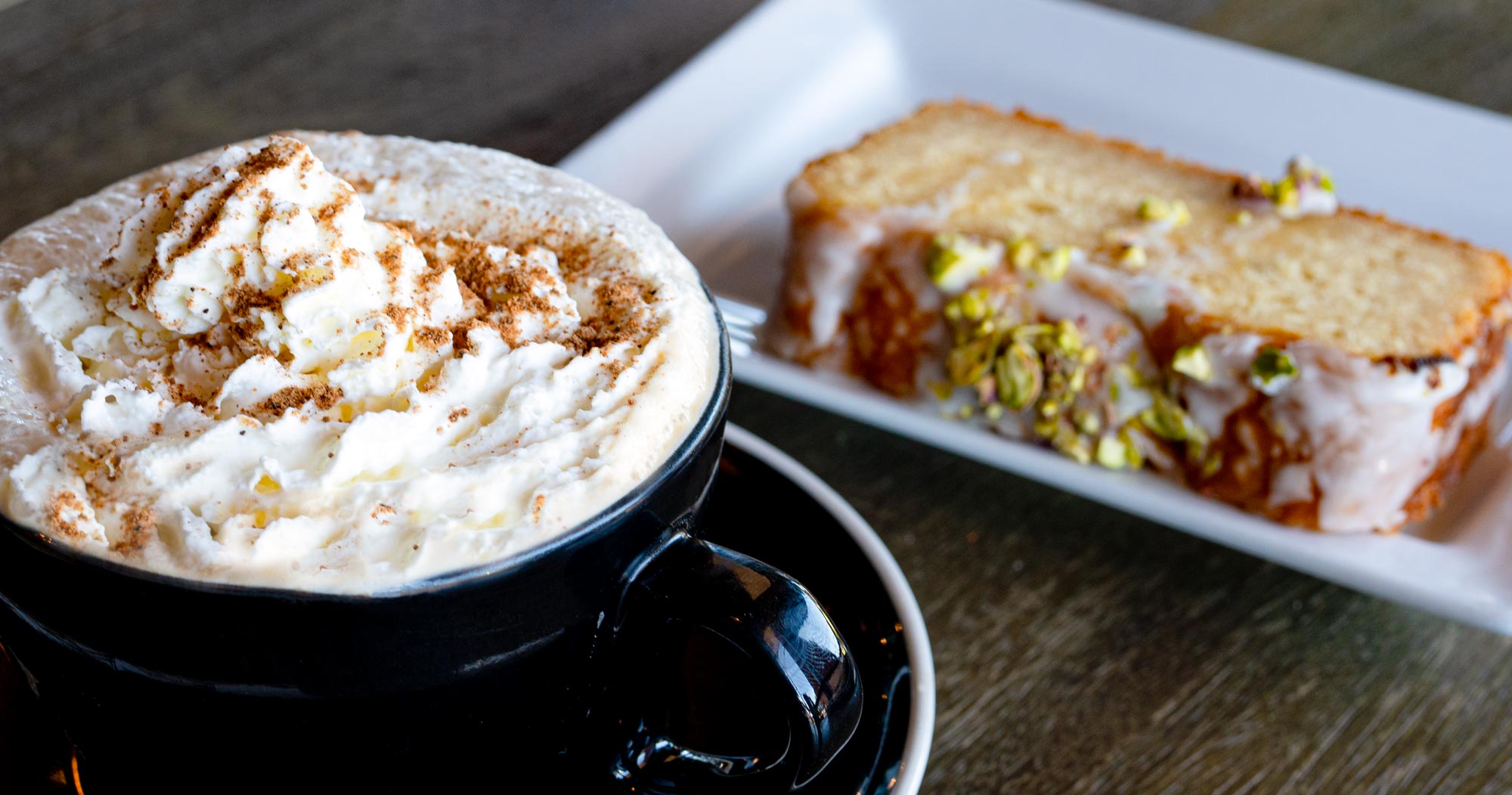 The Baked Maple Pumpkin Latte sitting next to bakery