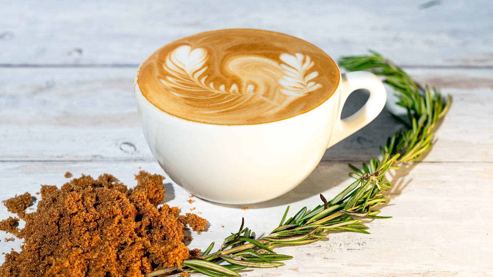 Brown Sugar Rosemary Latte in a cup on a wooden table