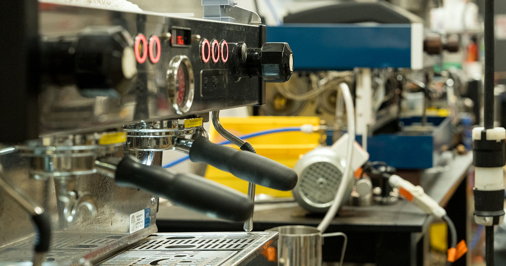 An espresso machine portafilter on a workbench in our workshop
