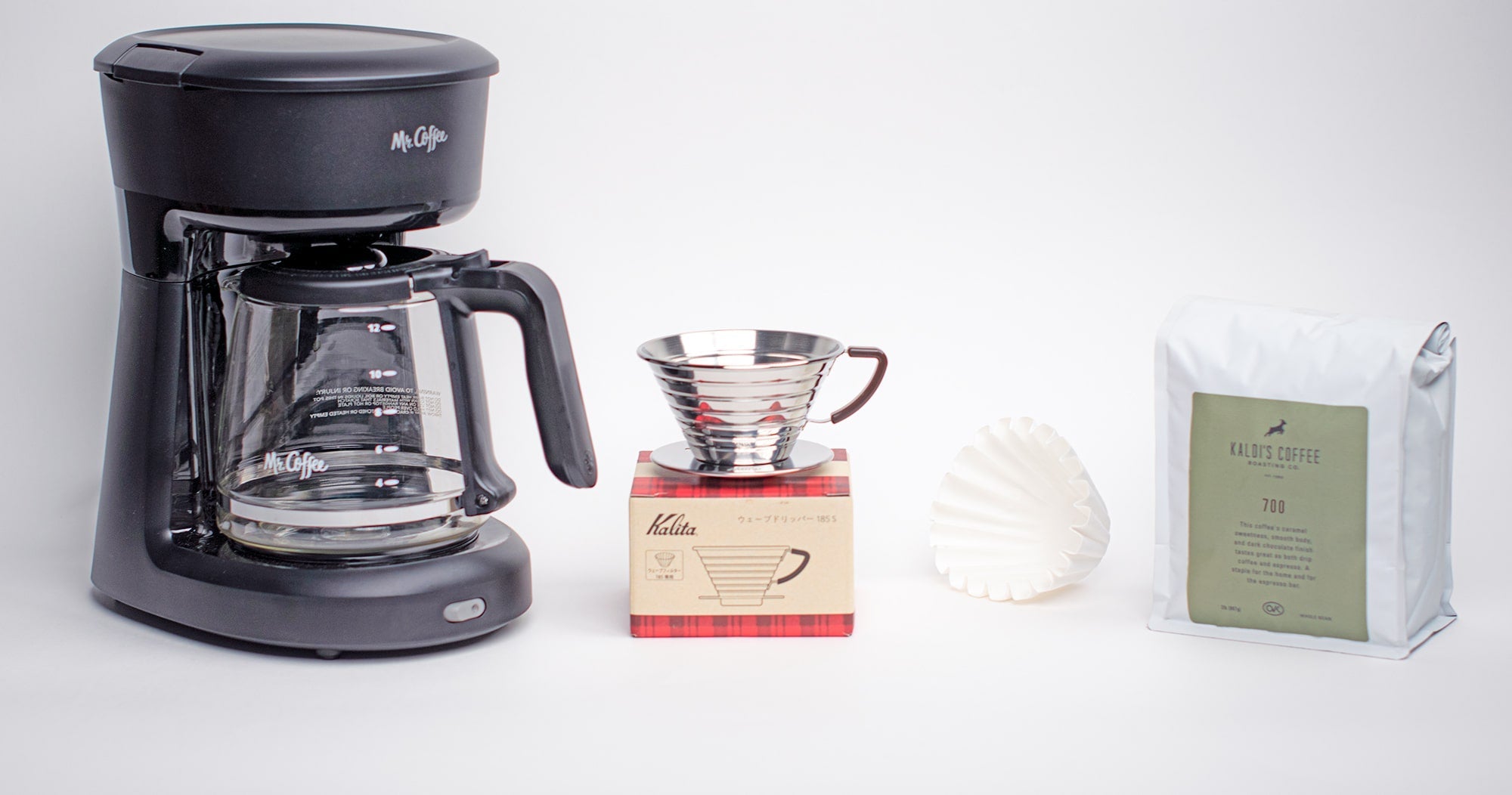 A Mr. Coffee automatic coffee brewer next to the Kalita Wave 185 and a 2lb bag of 700 blend