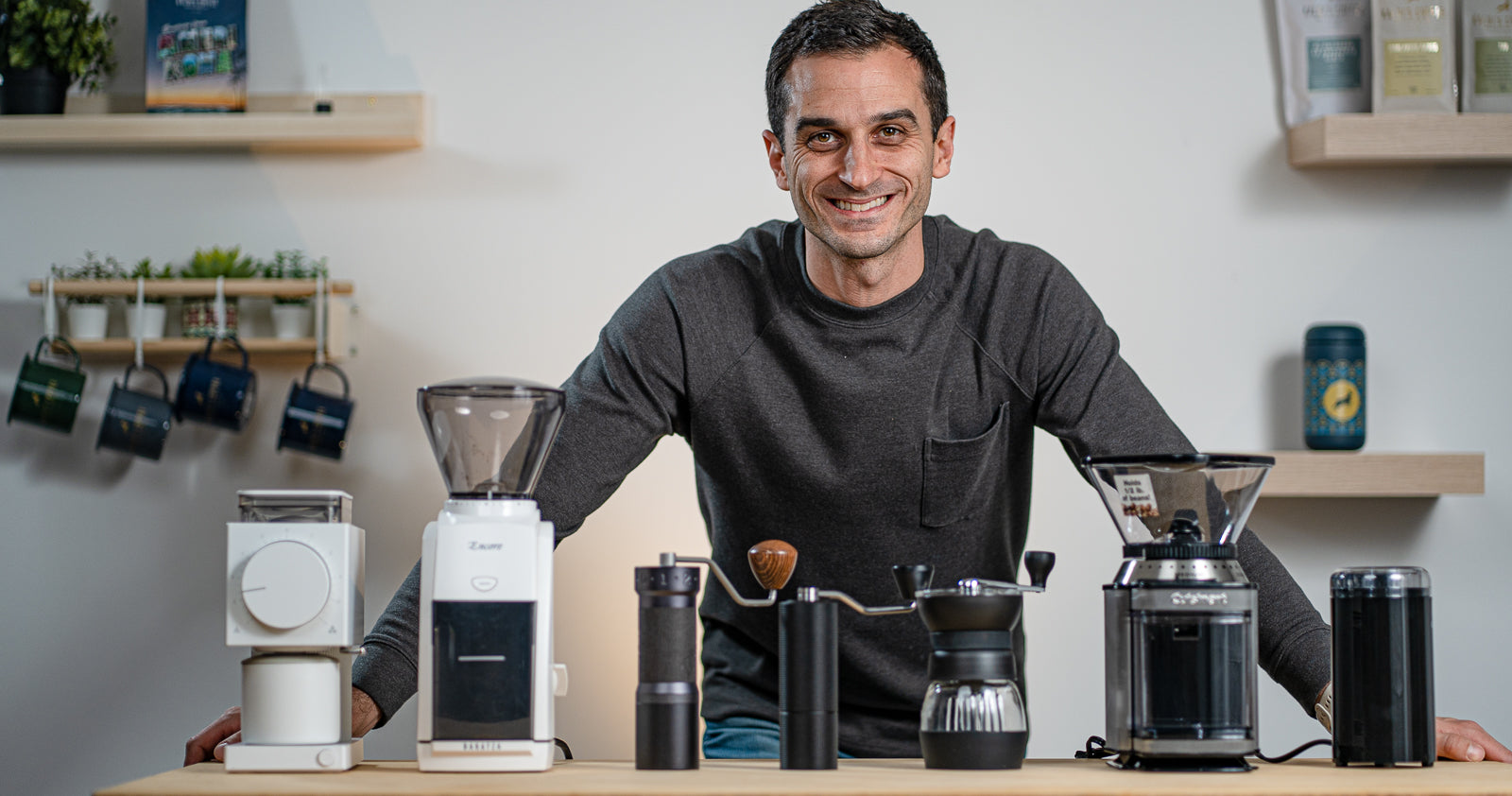 Rob standing next to a series of coffee grinders