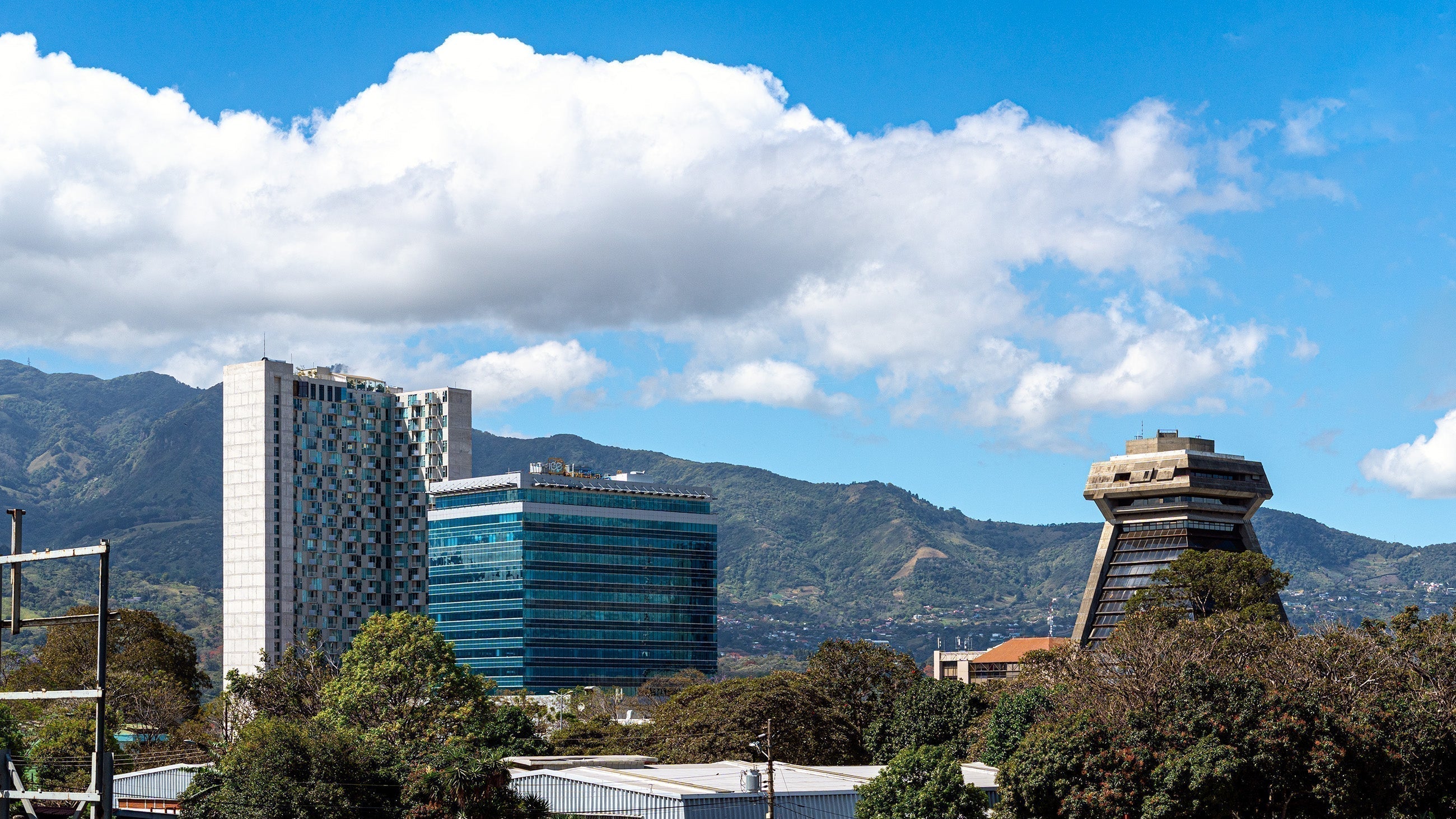 San Jose's skyline view looking to the south, tall buildings with mountains behind them