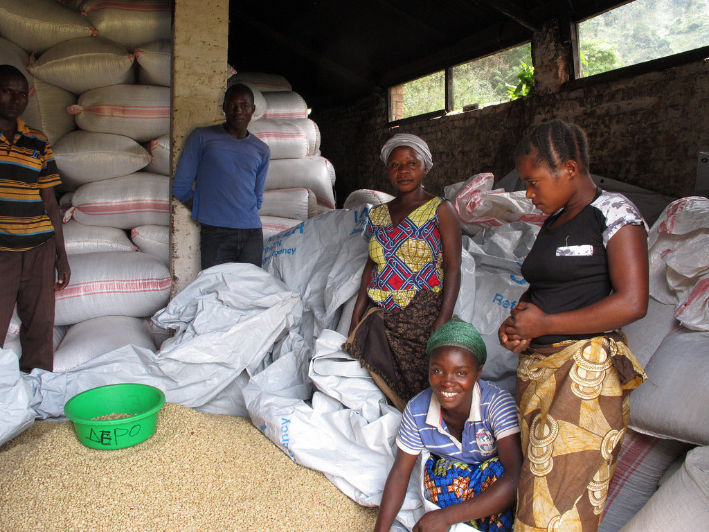image of farmers alongside bags of coffee