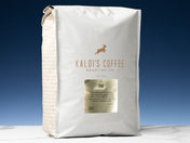 A 5lb bag of 700 sits on marble countertop in front of an uplit blue wall