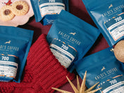 Kaldi's Coffee 4oz bags of 700 blend on a red fabric background with cookies.