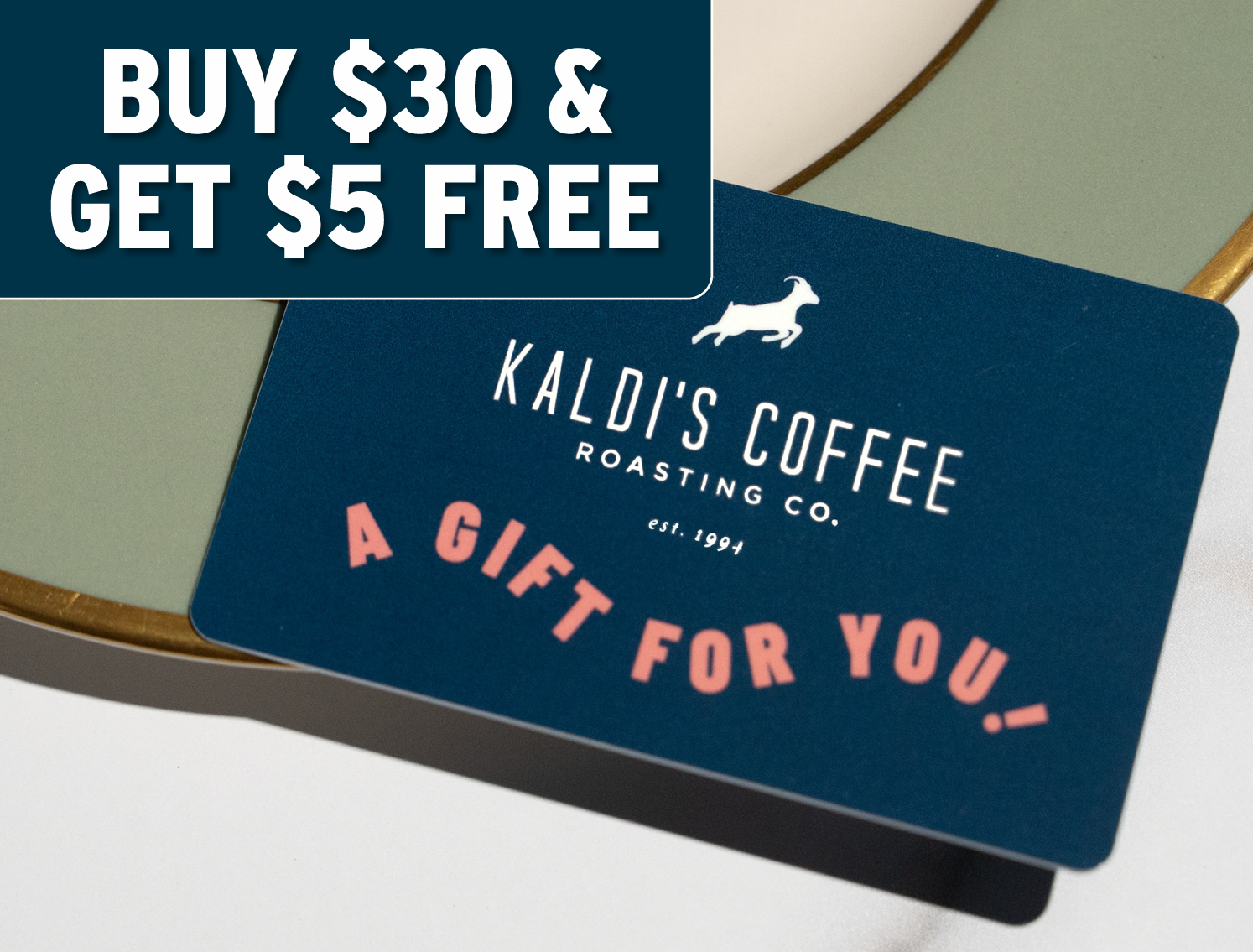 Kaldi's Coffee gift card with promotional text on a wooden surface