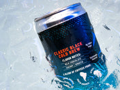 A dark blue can of Kaldi's Classic Black Cold Brew partially submerged in ice. The can reads "Classic Black Cold Brew" and lists flavor notes.