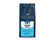 A product photo of a dark blue bag of coffee. The bag is rectangular with a resealable top. In the center is a white label with a drawing of a goat jumping over the words "Kaldi's Coffee Roasting Co."  Below that, the words "Dancing Goats" are in a unique font.  The label also lists tasting notes and a roast level indicator. The bag says "Whole Bean" at the bottom.