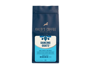 A product photo of a dark blue bag of coffee. The bag is rectangular with a resealable top. In the center is a white label with a drawing of a goat jumping over the words "Kaldi's Coffee Roasting Co."  Below that, the words "Dancing Goats" are in a unique font.  The label also lists tasting notes and a roast level indicator. The bag says "Whole Bean" at the bottom.