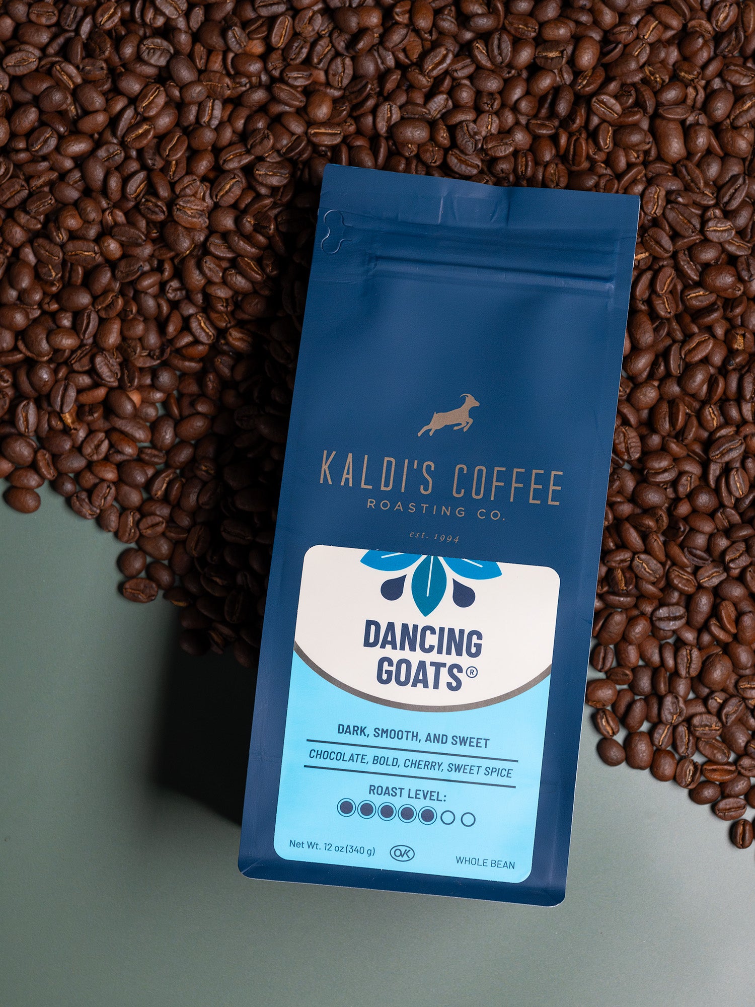 front image of Dancing Goats blend on top of roasted coffee beans