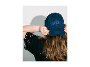 Person wearing a navy blue cap with 'EXPRESS' text on a white background