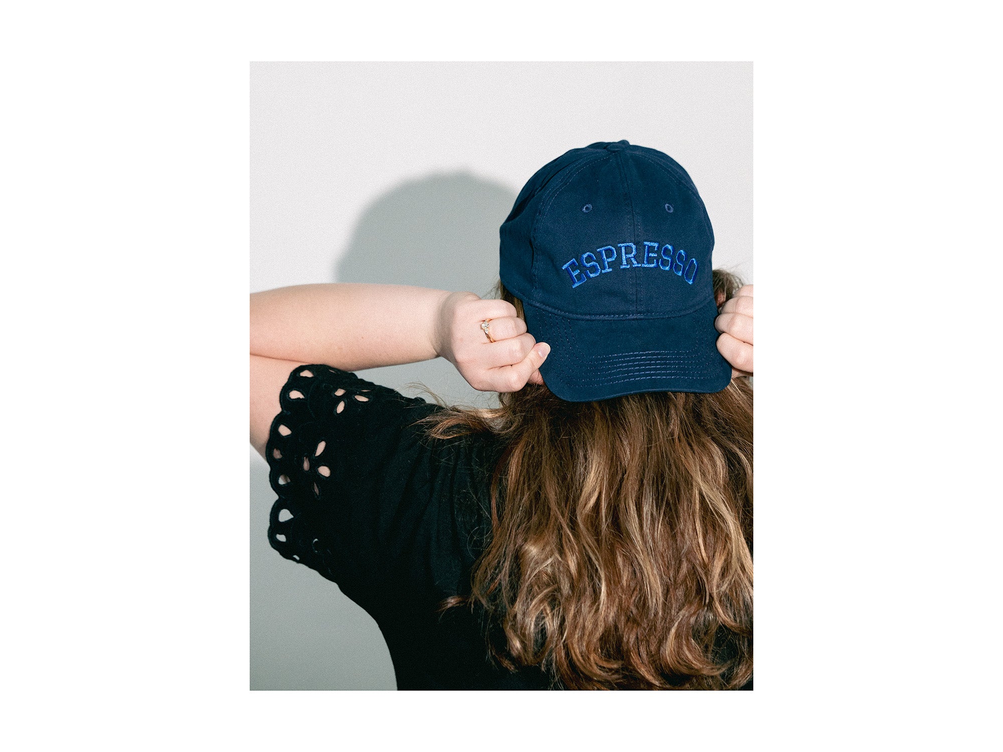 Person wearing a navy blue cap with 'EXPRESS' text on a white background