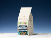 Kaldi's Coffee Ethiopia Agaro Yukro coffee bag on a white surface with a blue gradient background