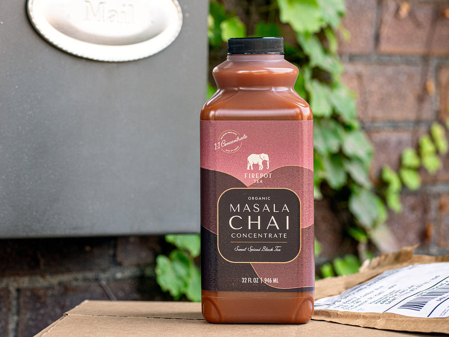 32oz bottle of Organic Masala Chai Concentrate on a doorstep