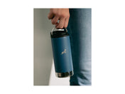 A blue Klean Canteen hangs low beside a leg, dangled from it's metal ring.