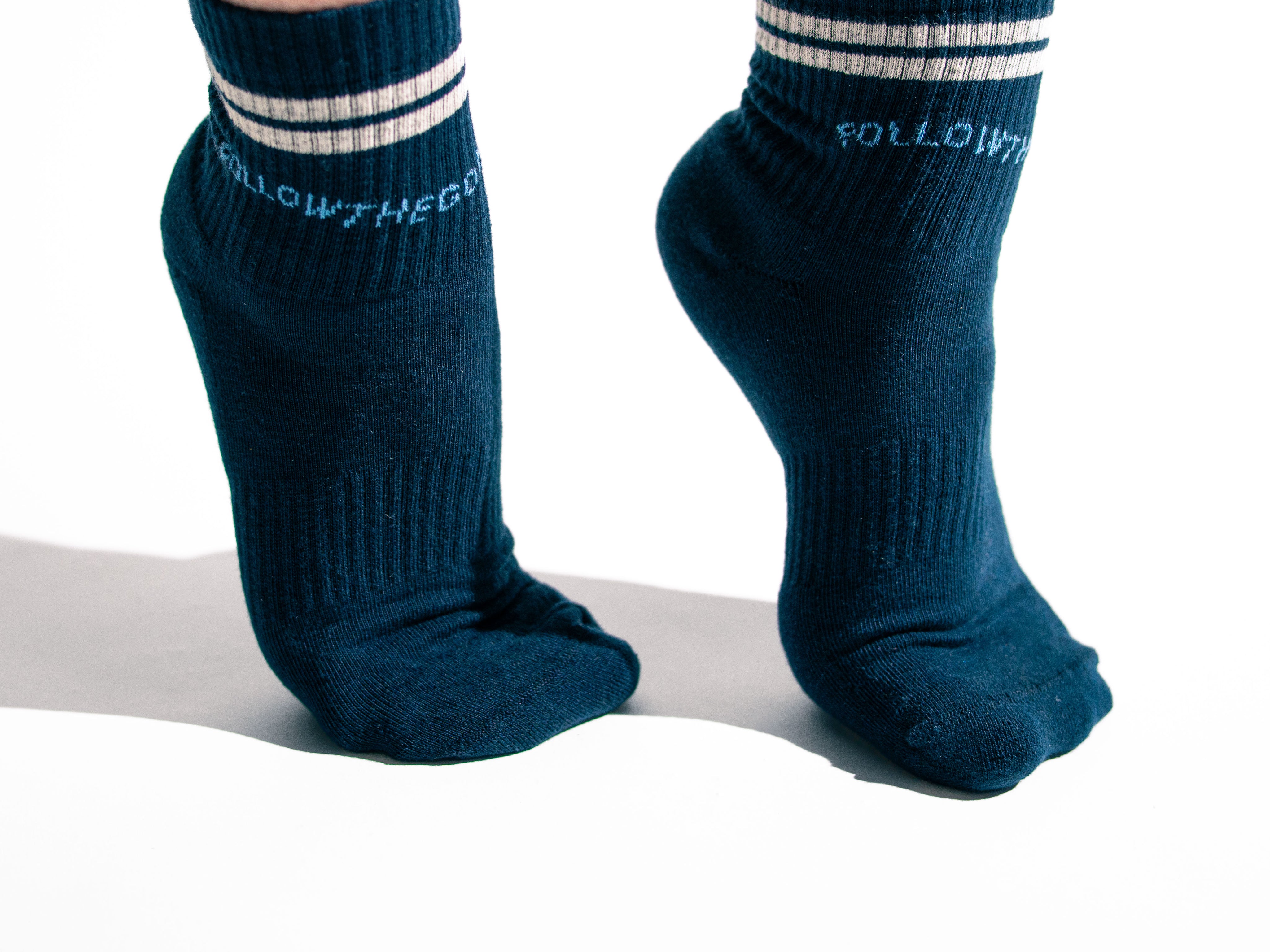 arched feet wearing navy socks