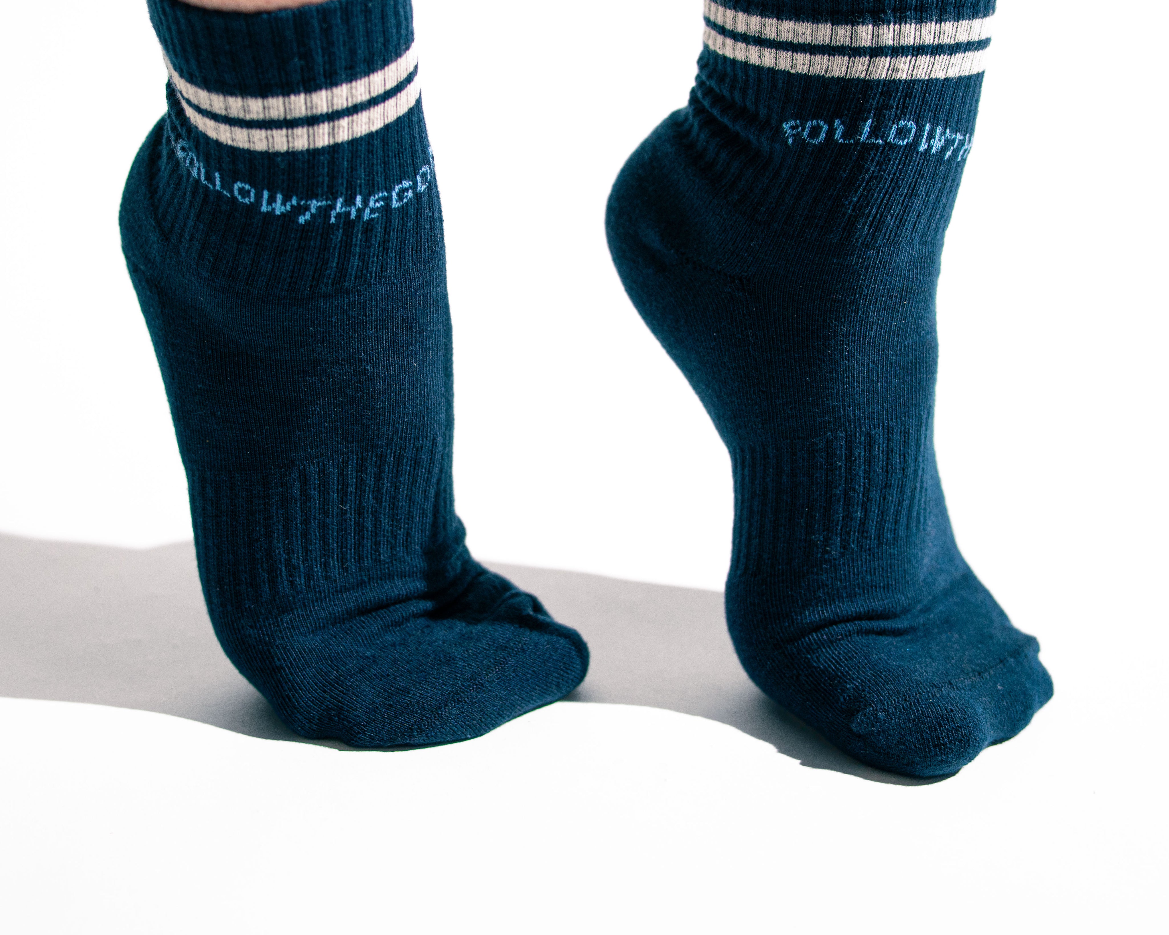 arched feet wearing navy socks