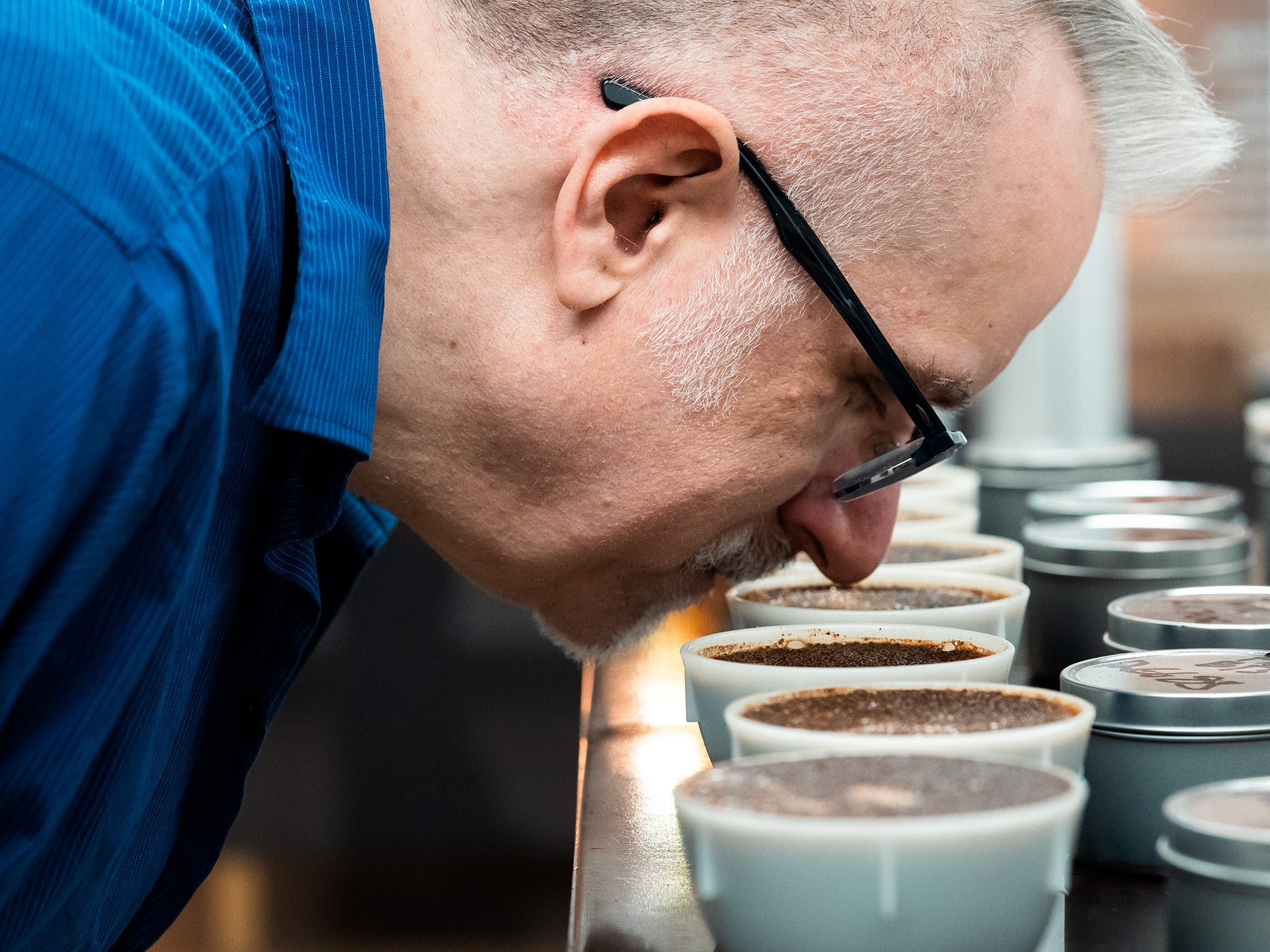 Dale getting the aroma from a coffee cupping bowl