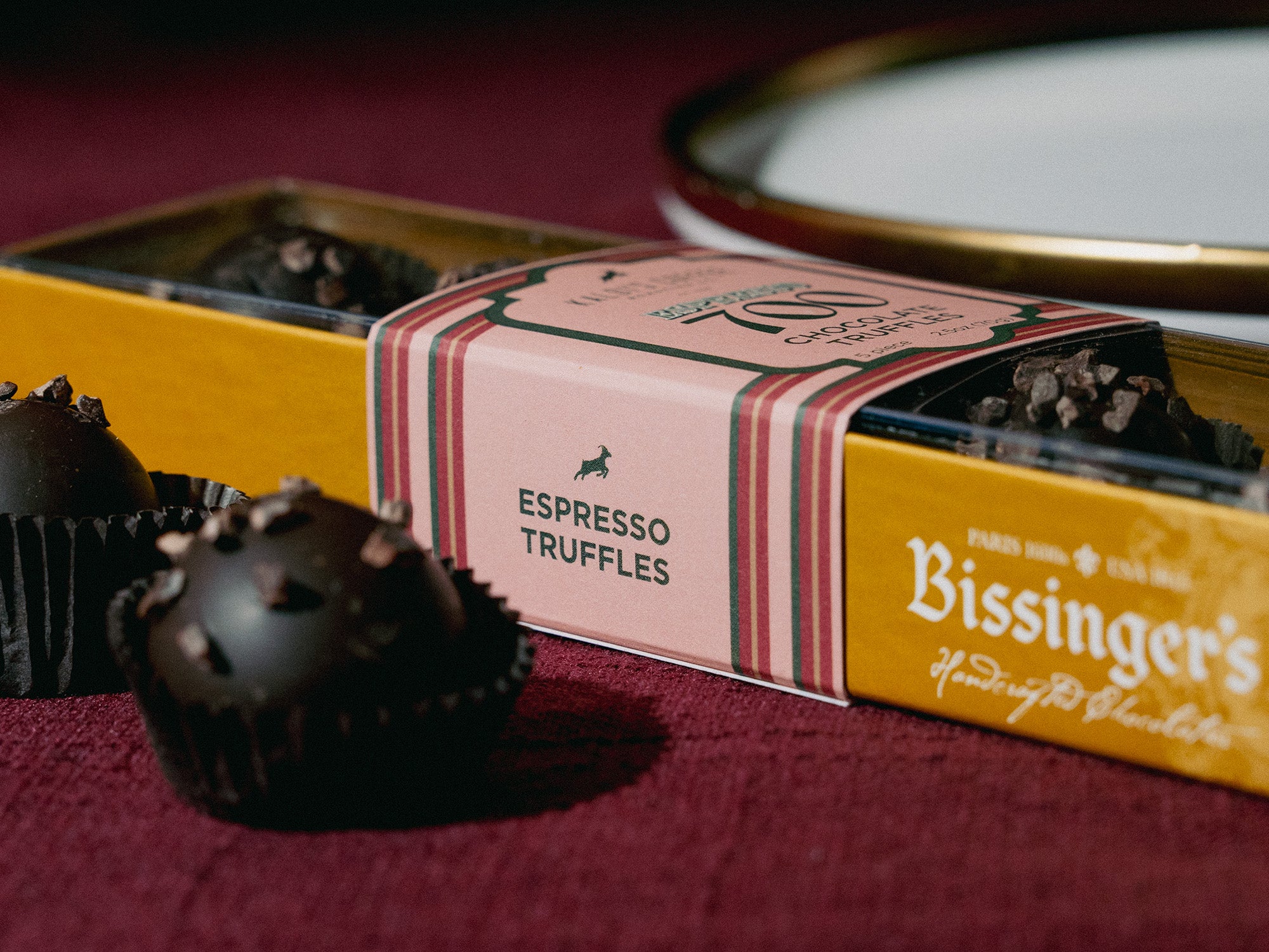 Bissinger's Espresso Truffles packaging with truffles on a red surface