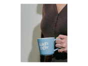 Image of hand holding kaldi's coffee blue mug