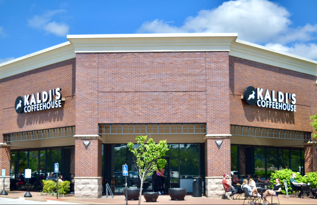 Kaldi's Coffeehouse building with people sitting outside on a sunny day