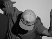 black and white photo of male wearing snap back grandpa style hat
