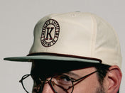 Male wearing snap back grandpa style hat showing side of hat