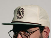 Male wearing snap back grandpa style hat showing side of hat