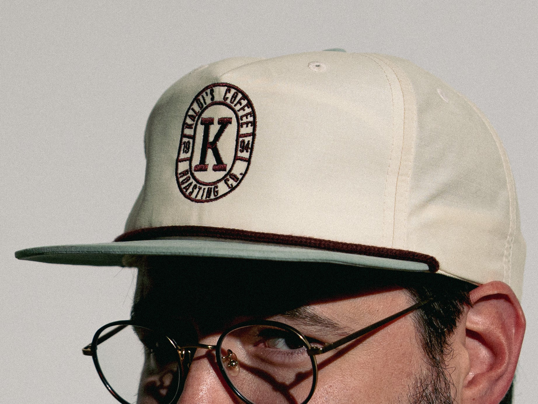 Male wearing snap back grandpa style hat showing side of hat