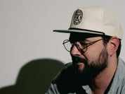 Male wearing snap back grandpa style hat