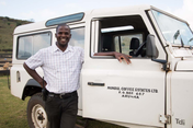 employee standing next to Mondul Estate car 