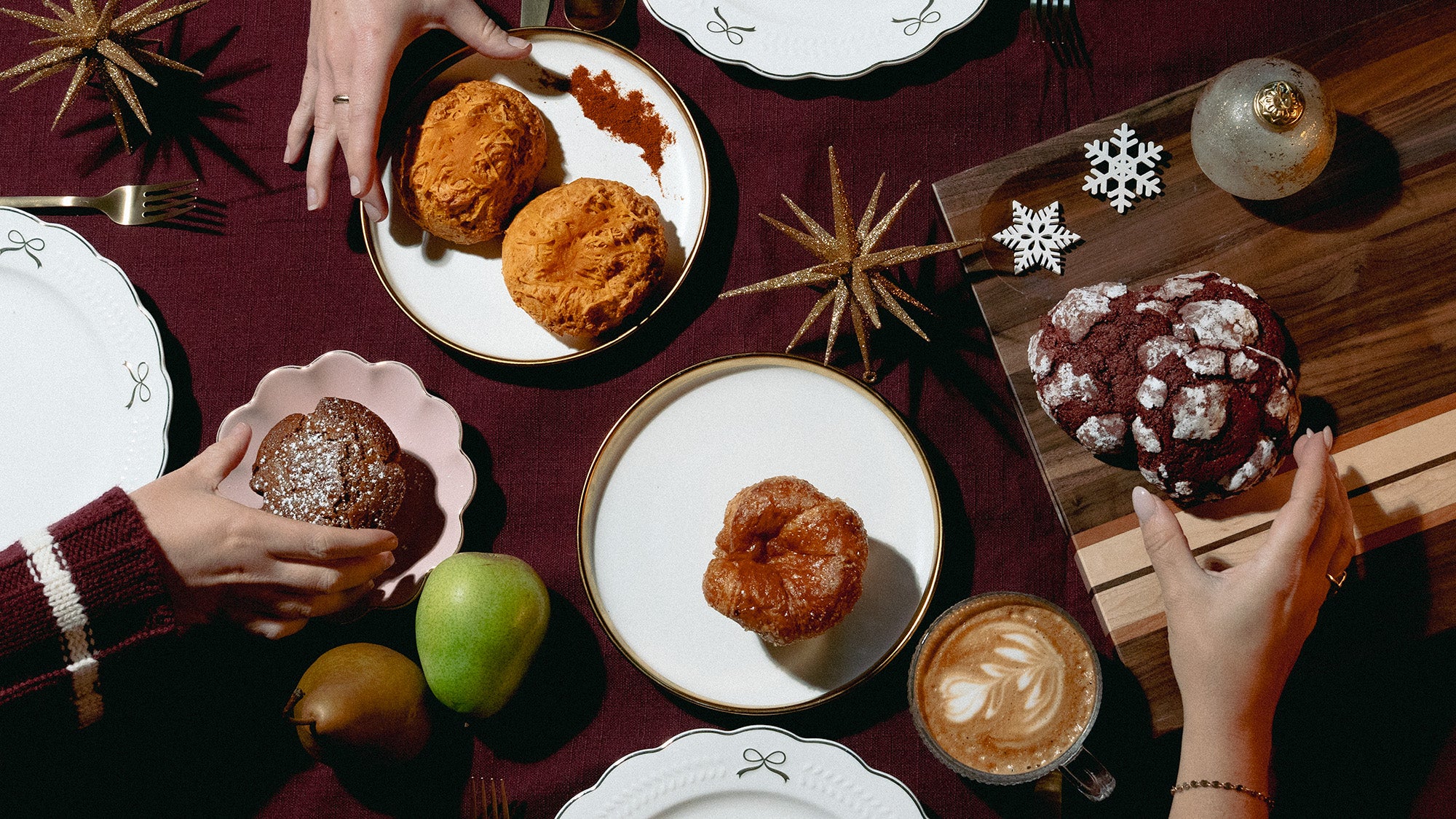 People enjoying a dessert时光 with cookies and coffee on a festive table setting.