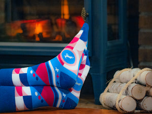 Kaldi's Geometric Pattern Socks with goat in front of a fireplace
